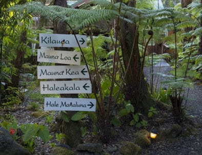 Directional signs in Volcano Village Lodge gardens
