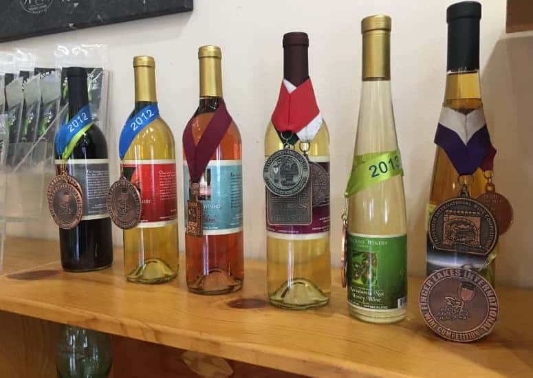 Wine bottles lined up on shelf