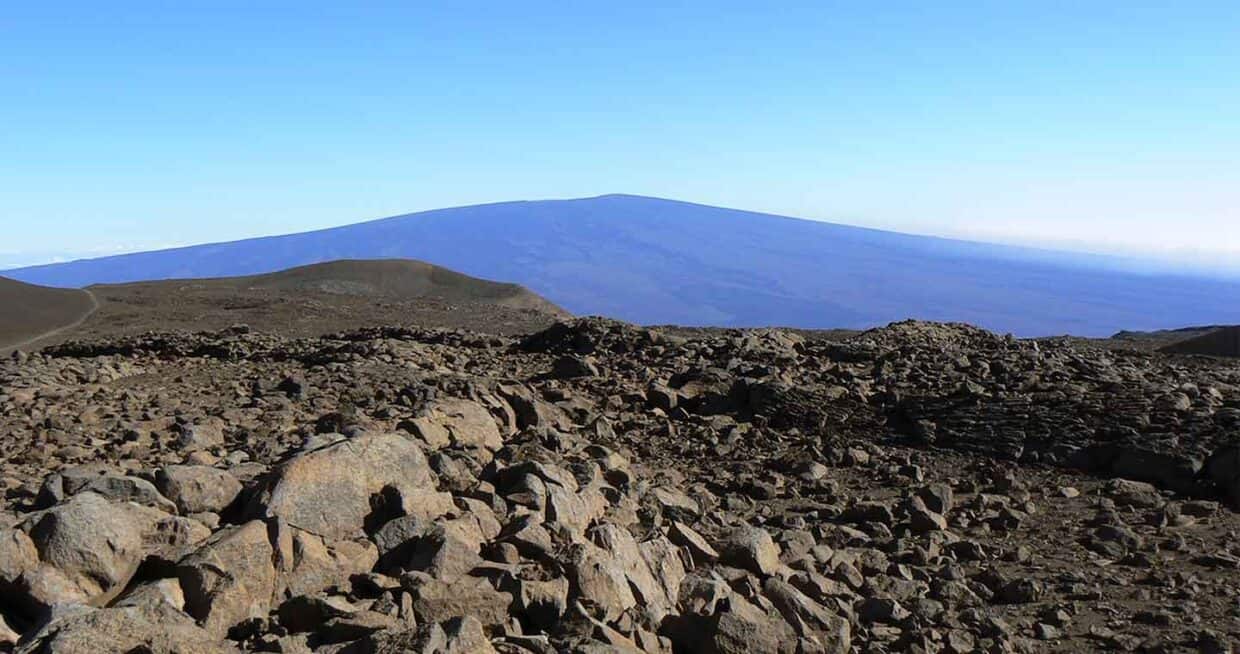 View of Mauna Loa from Mauna Kea -- high ground with lots of rocks.