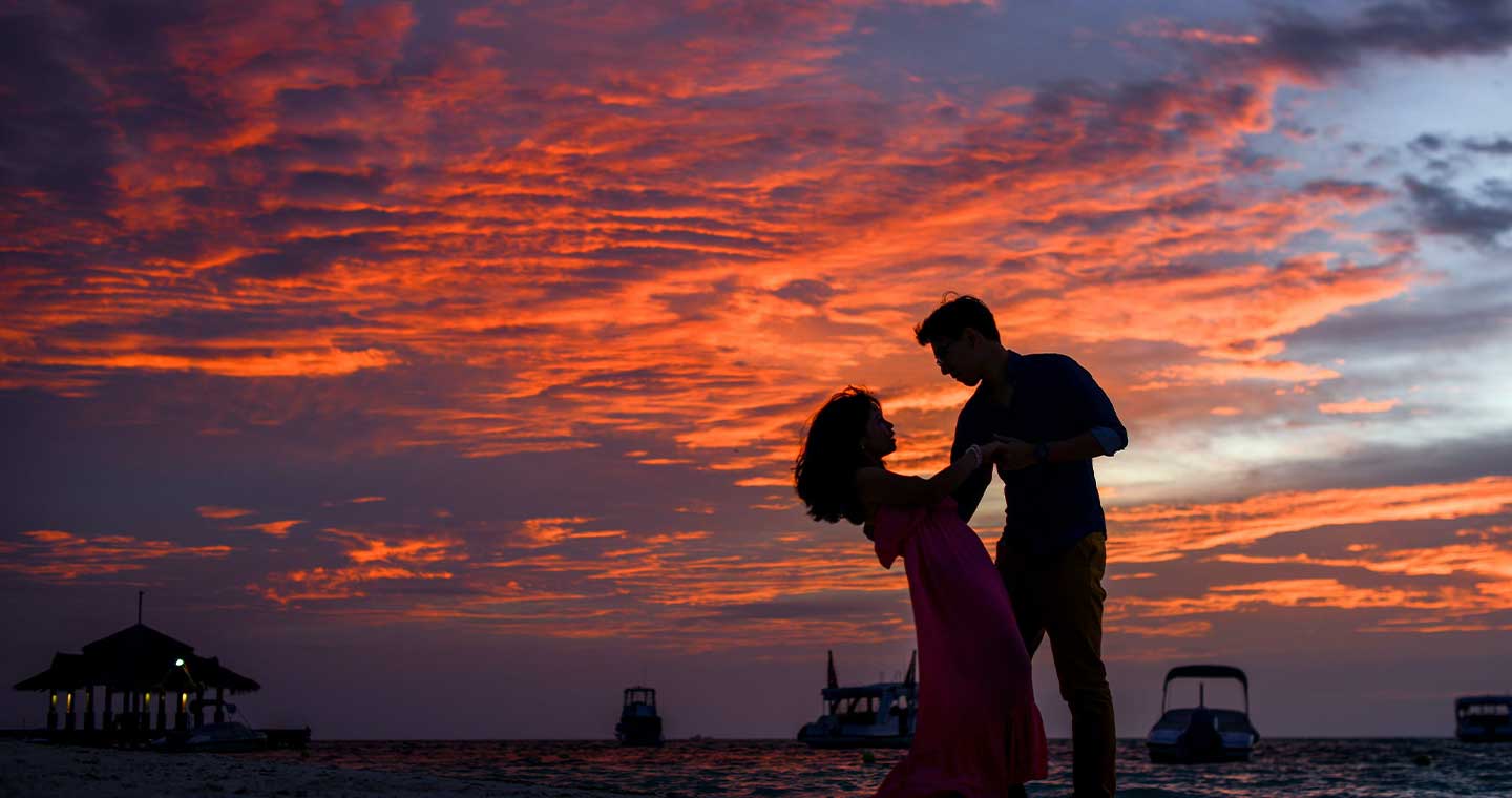 silhouette of a couple dancing before the sunset
