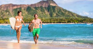 Couple Running on Beach In Hawaii