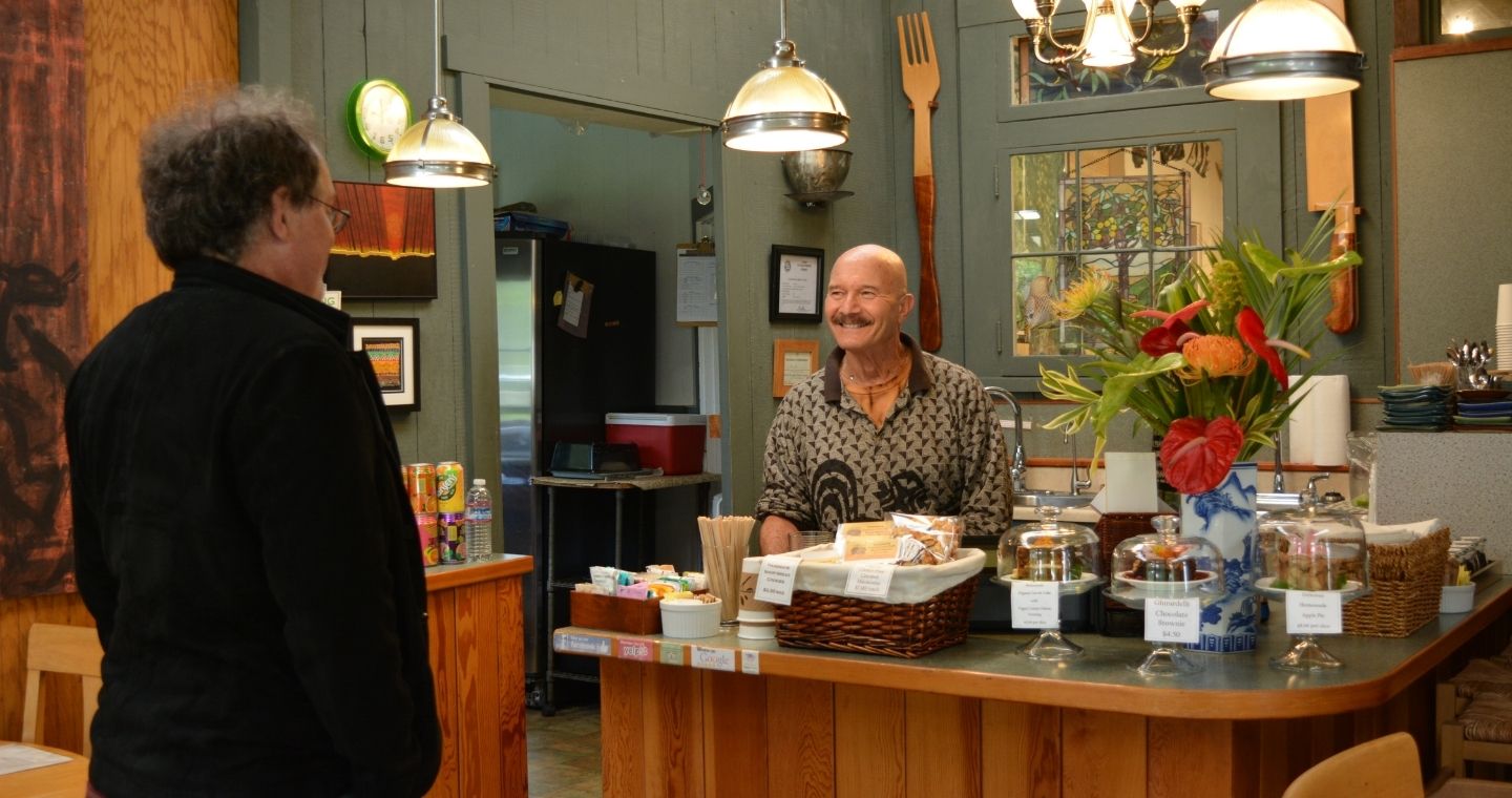 Ira Ono with a customer at Cafe Ono in Volcano, Hawaii