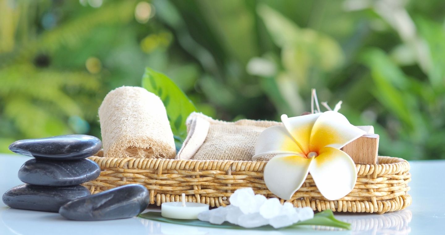 Basket of accessories and hot stones for hawaiian massage