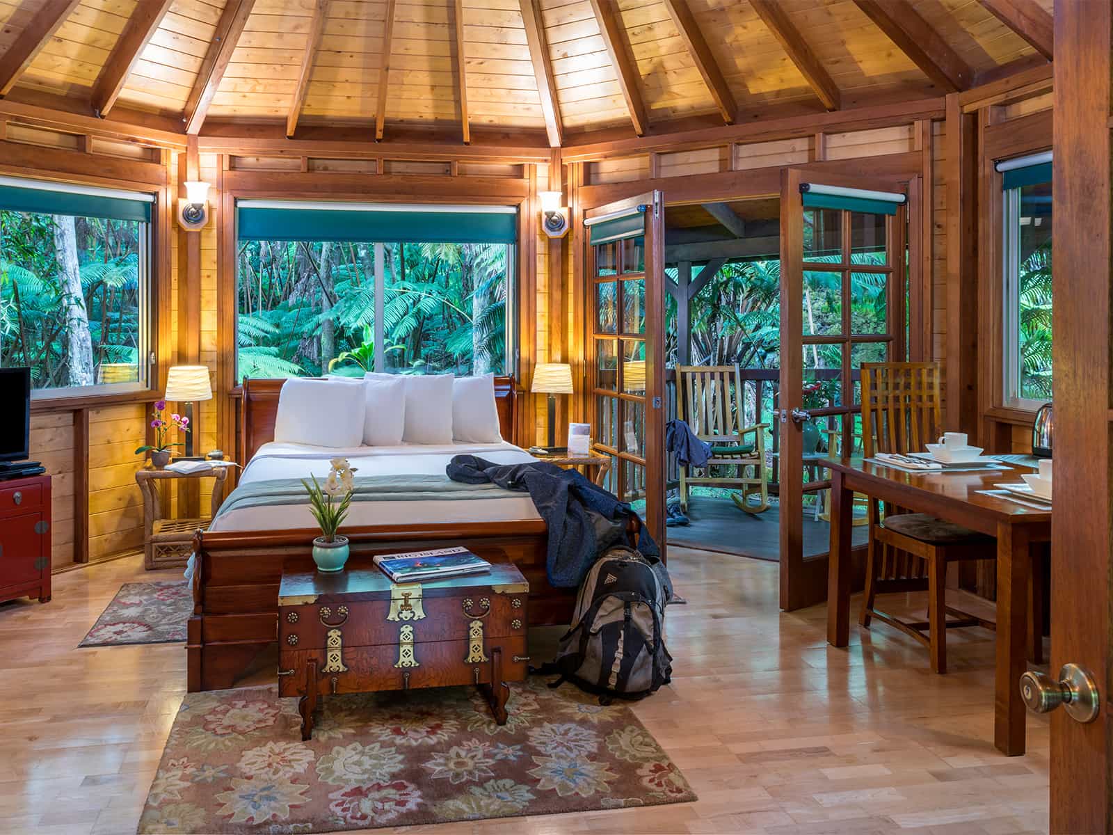Haleakala room with bed, wooden chest, and dining table