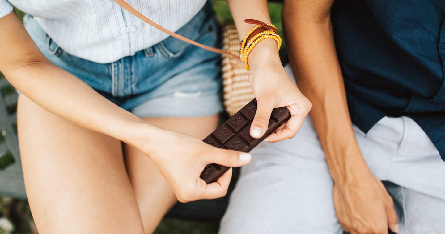 A couple sharing a bar of Hawaiian chocolate